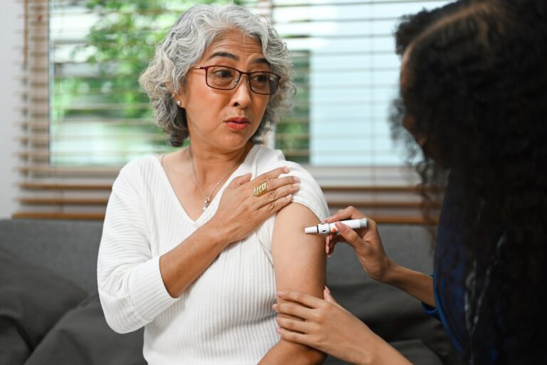 Senior female diabetes taking insulin from nurse. Diabetes and elderly healthcare concept.